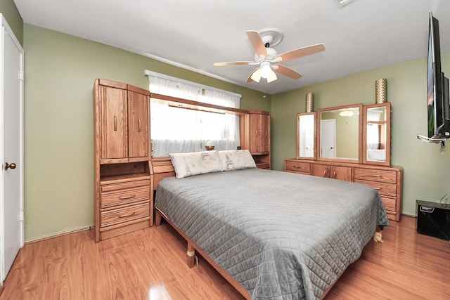 14518 Littleford St, Houston, TX 77045 - bedroom with light wood-style floors and a ceiling fan