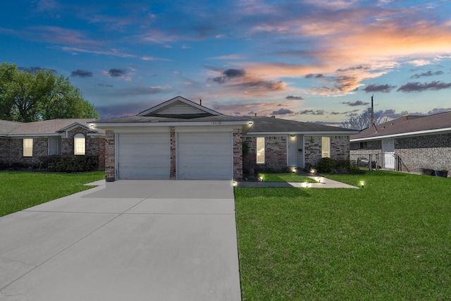 14518 Littleford St, Houston, TX 77045 - ranch-style home featuring a front yard, an attached garage, concrete driveway, and brick siding