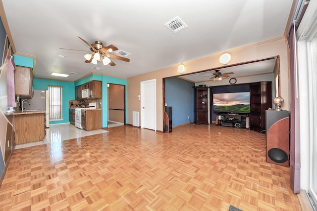 14518 Littleford St, Houston, TX 77045 - unfurnished living room featuring a ceiling fan, baseboards, ornamental molding, and a sink