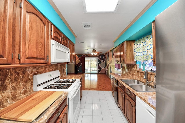 14518 Littleford St, Houston, TX 77045 - kitchen with white appliances, a sink, decorative backsplash, and ceiling fan