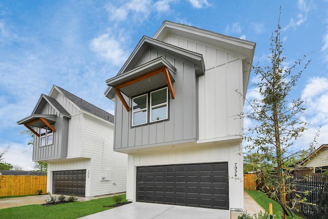 7931 Fields St, Houston, TX 77028 - view of front of house with concrete driveway, an attached garage, and board and batten siding