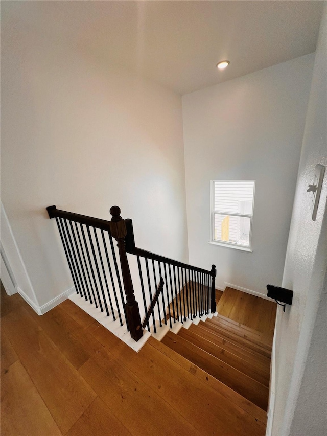 7931 Fields St, Houston, TX 77028 - stairs featuring hardwood / wood-style flooring, baseboards, and recessed lighting