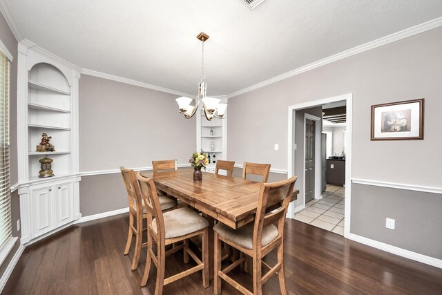 14011 Blazey Dr, Houston, TX 77095 - dining area featuring dark wood finished floors, a chandelier, ornamental molding, built in features, and baseboards