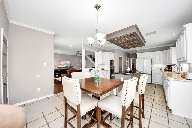 14011 Blazey Dr, Houston, TX 77095 - dining space with light tile patterned floors, a ceiling fan, ornamental molding, a chandelier, and recessed lighting