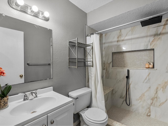 11731 Flushing Meadows Dr, Houston, TX 77089 - bathroom featuring a marble finish shower, toilet, a textured wall, and vanity