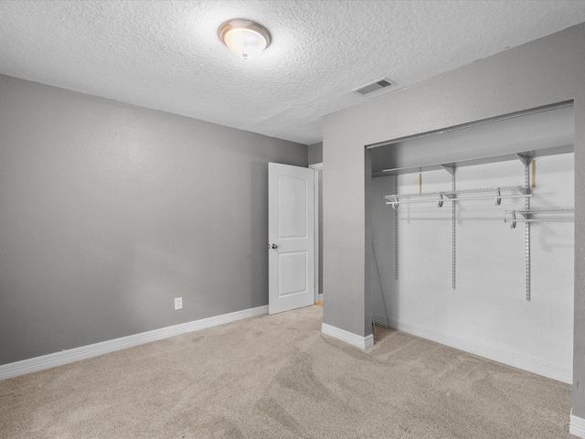 11731 Flushing Meadows Dr, Houston, TX 77089 - unfurnished bedroom featuring light colored carpet, a closet, a textured ceiling, and baseboards