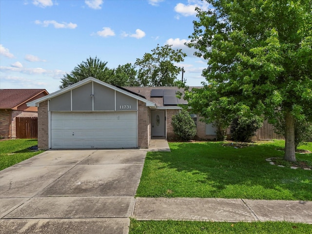 11731 Flushing Meadows Dr, Houston, TX 77089 - mid-century home featuring brick siding, solar panels, driveway, and an attached garage