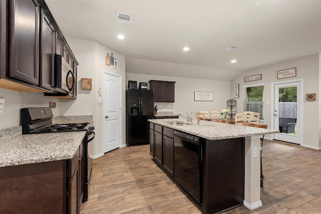 622 Rd 5138, Cleveland, TX 77327 - kitchen featuring black appliances, wood finished floors, a sink, dark brown cabinets, and recessed lighting