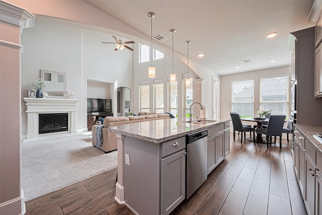 16826 Ellicott Rock Dr, Humble, TX 77346 - kitchen with dishwasher, gray cabinetry, a sink, ceiling fan, and an island with sink