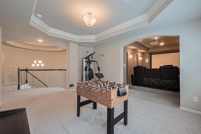 16826 Ellicott Rock Dr, Humble, TX 77346 - recreation room with a tray ceiling, carpet floors, arched walkways, ornamental molding, and a chandelier
