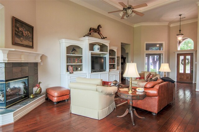 107 Edgewood Dr, Montgomery, TX 77356 - living room with a towering ceiling, hardwood / wood-style flooring, ceiling fan, ornamental molding, and a tile fireplace