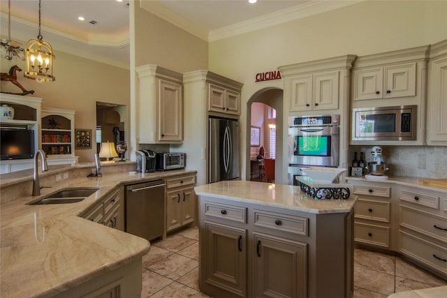 107 Edgewood Dr, Montgomery, TX 77356 - kitchen featuring appliances with stainless steel finishes, a sink, cream cabinetry, light stone counters, and decorative backsplash