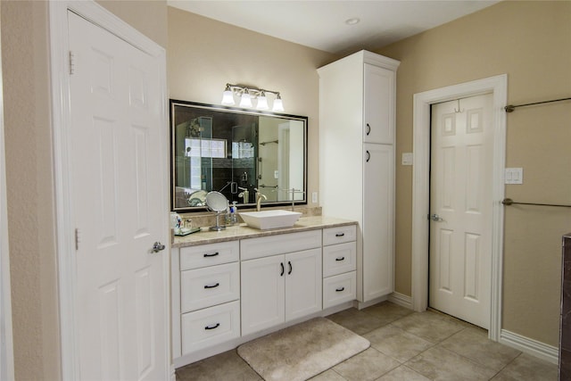 107 Edgewood Dr, Montgomery, TX 77356 - full bathroom featuring vanity, a shower with shower door, tile patterned floors, and baseboards
