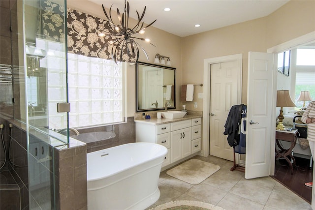 107 Edgewood Dr, Montgomery, TX 77356 - bathroom with vanity, a soaking tub, tile patterned flooring, a shower stall, and a chandelier