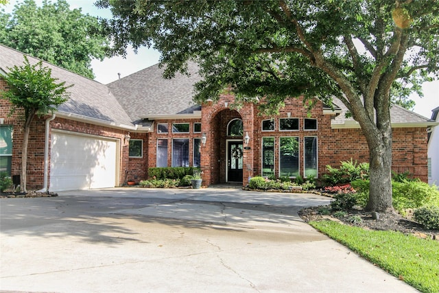 107 Edgewood Dr, Montgomery, TX 77356 - view of front of home with brick siding, driveway, and roof with shingles