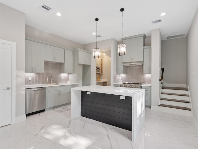 825 Paul Quinn St Unit E, Houston, TX 77091 - kitchen with appliances with stainless steel finishes, backsplash, gray cabinetry, under cabinet range hood, and light marble finish floors