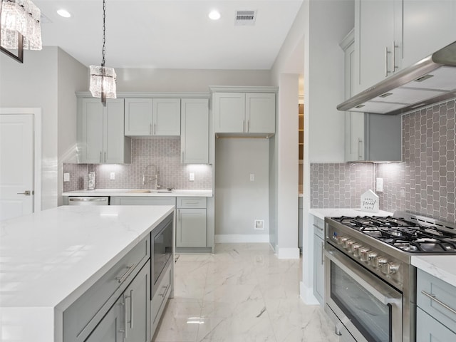 825 Paul Quinn St Unit E, Houston, TX 77091 - kitchen featuring appliances with stainless steel finishes, a sink, gray cabinetry, backsplash, and under cabinet range hood