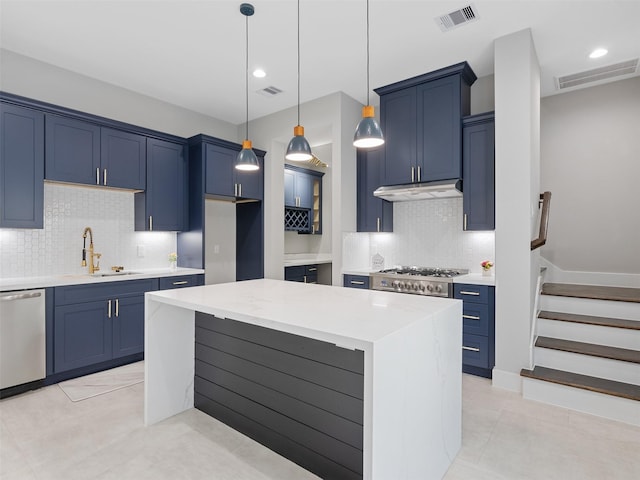 825 Paul Quinn St Unit E, Houston, TX 77091 - kitchen featuring blue cabinets, stainless steel dishwasher, decorative backsplash, under cabinet range hood, and recessed lighting
