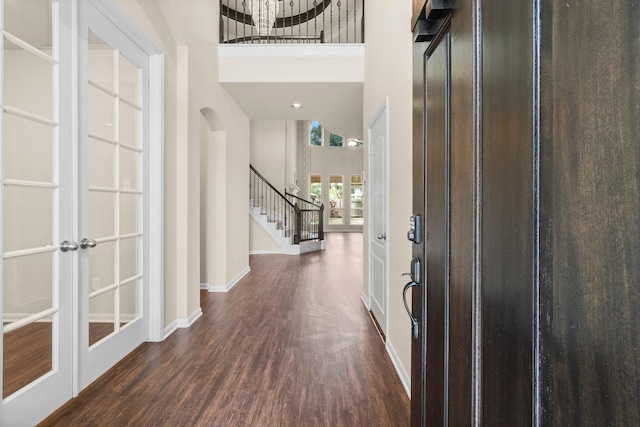 27303 Balson Forest Ln, Spring, TX 77386 - foyer with dark wood-style flooring, stairs, baseboards, and a high ceiling