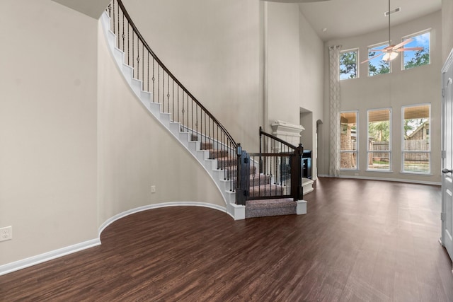 27303 Balson Forest Ln, Spring, TX 77386 - foyer featuring wood finished floors, a towering ceiling, stairs, ceiling fan, and baseboards