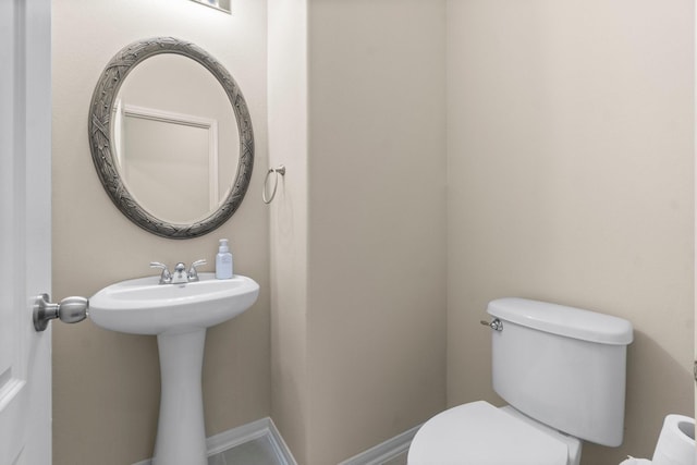 27303 Balson Forest Ln, Spring, TX 77386 - bathroom with toilet, a sink, and baseboards