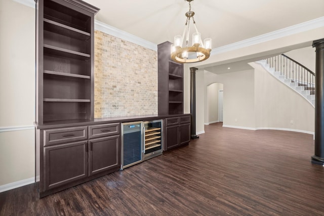 27303 Balson Forest Ln, Spring, TX 77386 - bar area featuring arched walkways, baseboards, a chandelier, dark wood-type flooring, and beverage cooler
