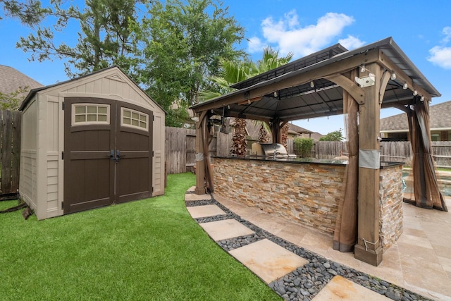 27303 Balson Forest Ln, Spring, TX 77386 - view of yard with a gazebo, an outdoor kitchen, and a patio area