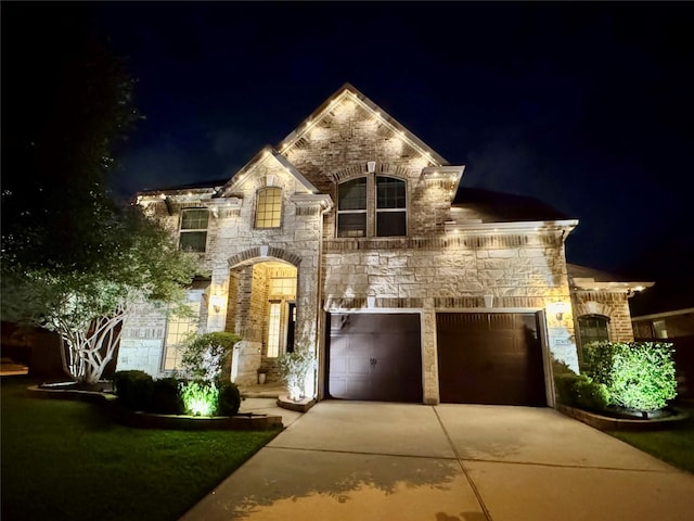 27303 Balson Forest Ln, Spring, TX 77386 - french country style house with concrete driveway, stone siding, a garage, and brick siding