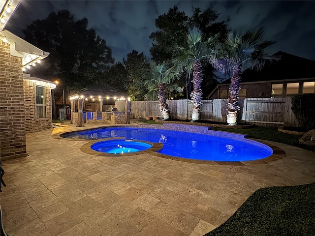 27303 Balson Forest Ln, Spring, TX 77386 - pool at night with a gazebo, an in-ground hot tub, a patio, a fenced backyard, and a bar