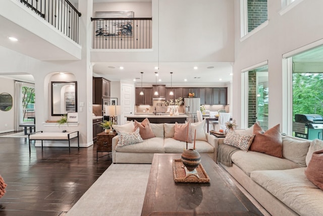 13710 Nubenbrook Lake Dr, Houston, TX 77044 - living area with a towering ceiling, healthy amount of natural light, dark wood-style floors, recessed lighting, and baseboards