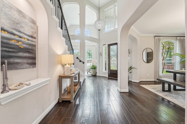 13710 Nubenbrook Lake Dr, Houston, TX 77044 - entryway featuring arched walkways, dark wood-style floors, baseboards, and a towering ceiling