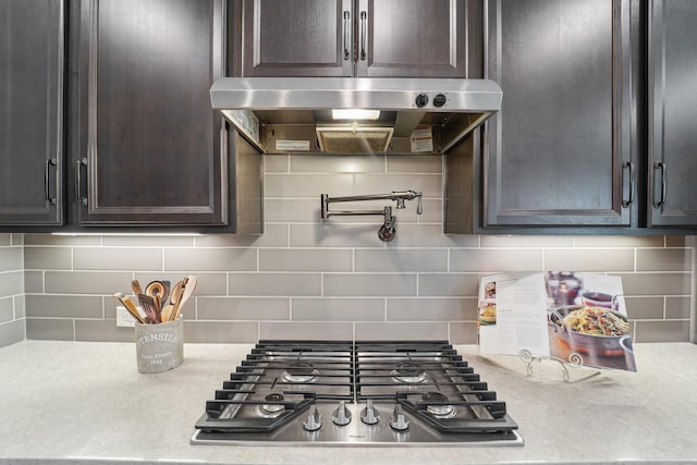13710 Nubenbrook Lake Dr, Houston, TX 77044 - kitchen featuring exhaust hood, stainless steel gas stovetop, light countertops, and dark brown cabinets