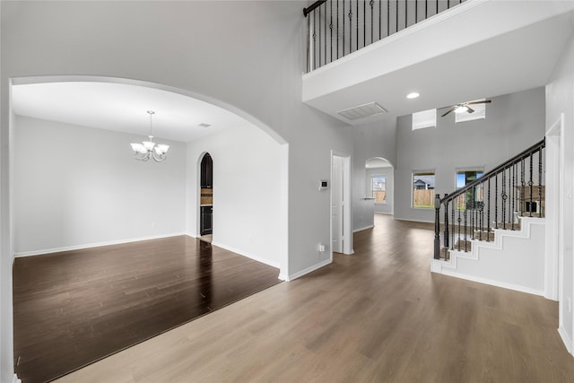 11915 Eagle Ridge Dr, Mont Belvieu, TX 77535 - entryway with a high ceiling, ceiling fan, wood finished floors, arched walkways, and baseboards