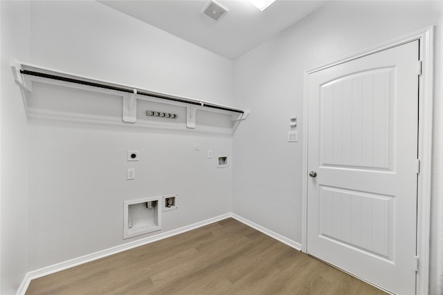 11915 Eagle Ridge Dr, Mont Belvieu, TX 77535 - laundry area with hookup for an electric dryer, hookup for a gas dryer, wood finished floors, hookup for a washing machine, and baseboards