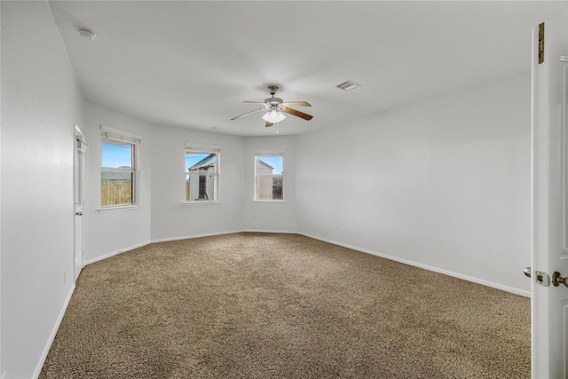 11915 Eagle Ridge Dr, Mont Belvieu, TX 77535 - empty room featuring a ceiling fan, carpet floors, and healthy amount of natural light
