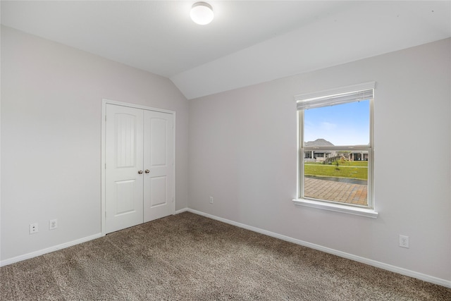 11915 Eagle Ridge Dr, Mont Belvieu, TX 77535 - unfurnished bedroom with carpet floors, lofted ceiling, baseboards, and a closet