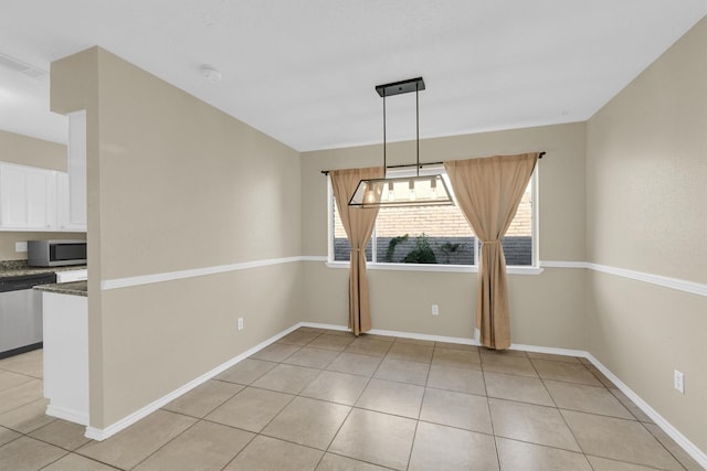 4803 Bridgemont Ln, Spring, TX 77388 - unfurnished dining area with plenty of natural light, light tile patterned flooring, and baseboards