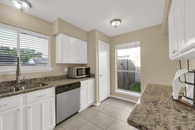 4803 Bridgemont Ln, Spring, TX 77388 - kitchen featuring stainless steel appliances, a sink, white cabinets, light stone countertops, and light tile patterned floors