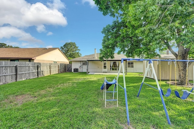 4803 Bridgemont Ln, Spring, TX 77388 - back of property with central air condition unit, a playground, and a patio