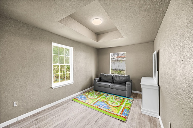 12910 Green River Dr, Houston, TX 77044 - game room featuring a textured wall, wood finished floors, a textured ceiling, and baseboards