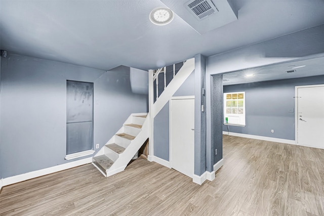 12910 Green River Dr, Houston, TX 77044 - basement featuring wood finished floors, stairs, and baseboards