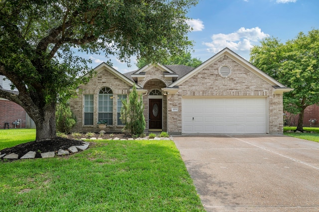 20711 Medallion Pointe Dr, Katy, TX 77450 - view of front facade with a garage, driveway, a front yard, and brick siding