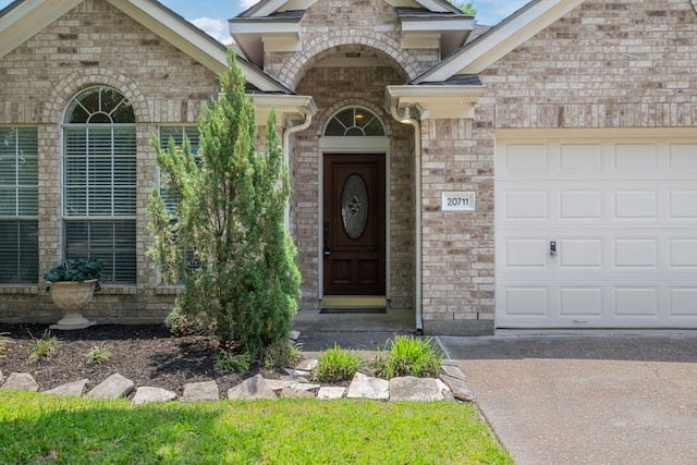 20711 Medallion Pointe Dr, Katy, TX 77450 - entrance to property with an attached garage, brick siding, and driveway