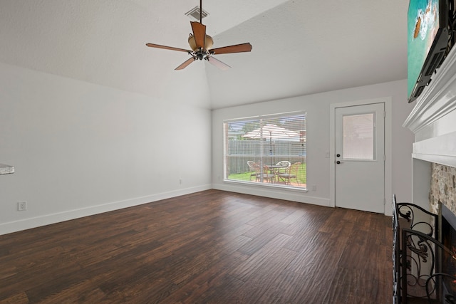 20711 Medallion Pointe Dr, Katy, TX 77450 - unfurnished living room with a stone fireplace, vaulted ceiling, dark wood-type flooring, ceiling fan, and baseboards