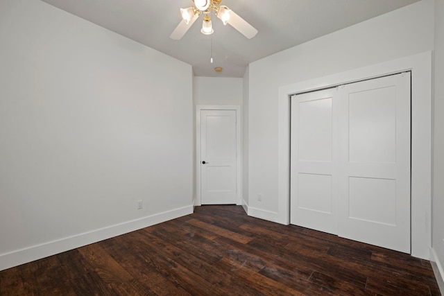 20711 Medallion Pointe Dr, Katy, TX 77450 - unfurnished bedroom with dark wood-style flooring, baseboards, a closet, and a ceiling fan
