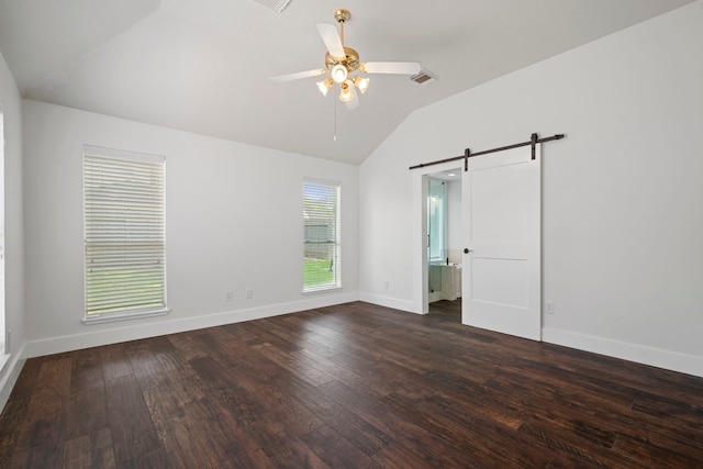 20711 Medallion Pointe Dr, Katy, TX 77450 - unfurnished bedroom with a barn door, lofted ceiling, dark wood-style floors, baseboards, and a ceiling fan