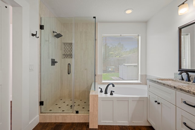 20711 Medallion Pointe Dr, Katy, TX 77450 - bathroom with a garden tub, a stall shower, wood finished floors, and vanity