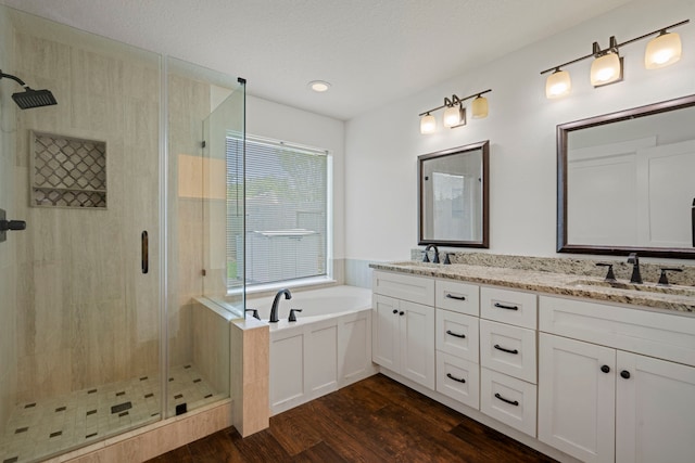20711 Medallion Pointe Dr, Katy, TX 77450 - full bath featuring wood finished floors, a shower stall, a bath, and double vanity