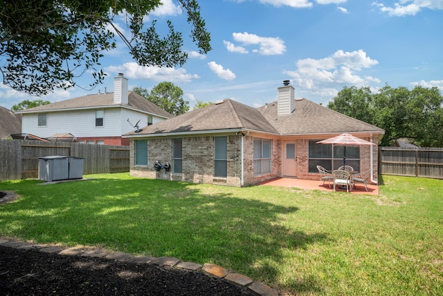 20711 Medallion Pointe Dr, Katy, TX 77450 - back of property featuring brick siding, a patio, a chimney, and a shingled roof