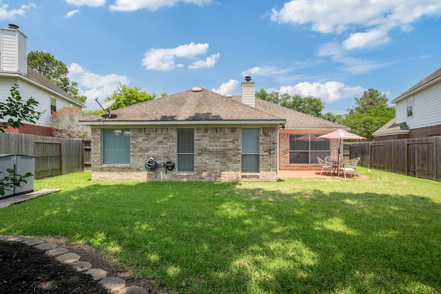20711 Medallion Pointe Dr, Katy, TX 77450 - rear view of property featuring brick siding, a shingled roof, a chimney, and a patio area